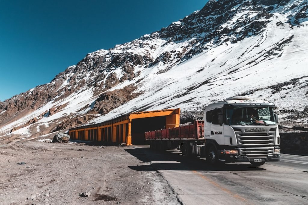 white-and-orange-truck-flyqy4wmkci truck crossing the mountains